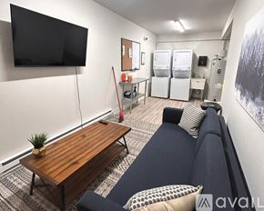 Coeur D'alene apartment for rent - A living room with a couch, a coffee table, and a television.