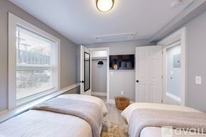 Providence apartment for rent - A bedroom with two beds and a basket on the floor.