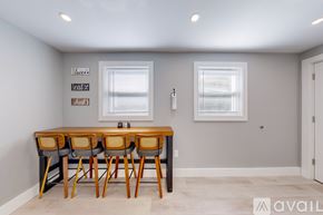 Providence apartment for rent - A dining room with a wooden table and chairs.