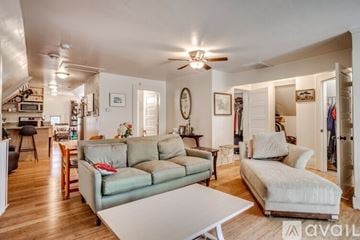 Minneapolis house for rent - A living room with a green couch and a white couch.