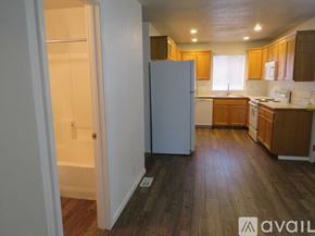 Boise townhouse for rent - A kitchen with wooden floors and white appliances.