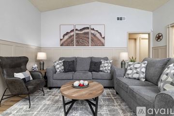 Frisco house for rent - A living room with a grey couch, a chair, a coffee table, and a painting on the wall.