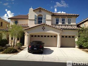Las Vegas apartment for rent - A black car is parked in front of a two-car garage.