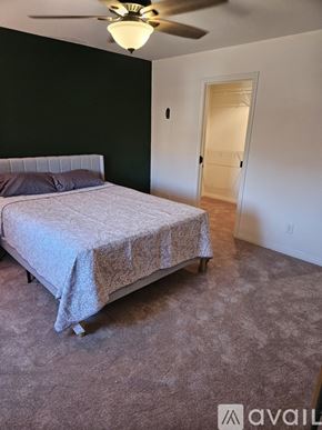 Las Vegas apartment for rent - A bedroom with a bed and a ceiling fan.
