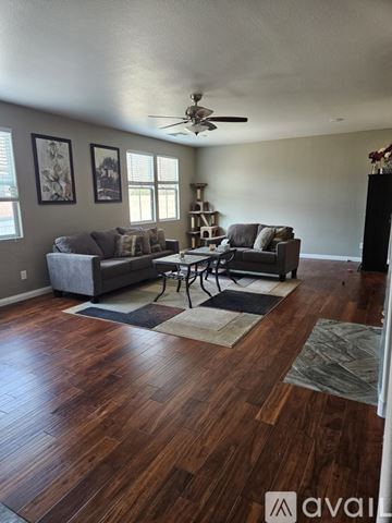 Las Vegas apartment for rent - A living room with a grey couch and a wooden floor.