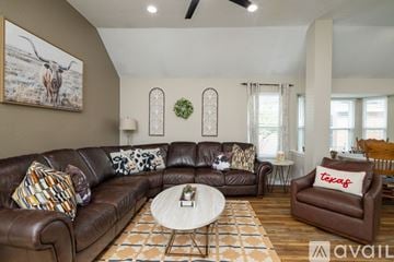Mckinney house for rent - A living room with a brown leather couch and a coffee table.