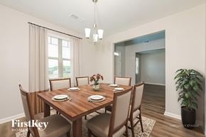 Winder house for rent - A dining room with a wooden table set for four.