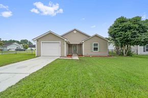 Jacksonville house for rent - A house with a garage and a driveway in front.