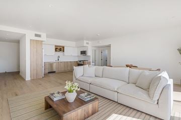 Los Angeles apartment for rent - A white couch sits in a living room with a coffee table in front of it.
