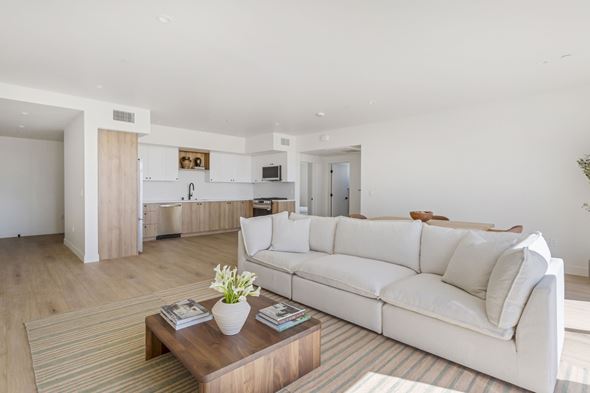 Los Angeles apartment for rent - A white couch sits in a living room with a coffee table in front of it.