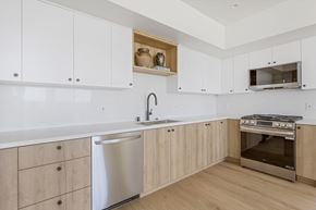 Los Angeles apartment for rent - A modern kitchen with wooden cabinets and stainless steel appliances.