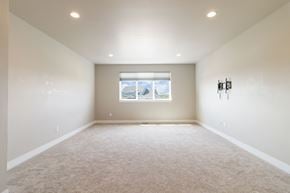 Castle Rock house for rent - A spacious room with a window and carpeted floor.