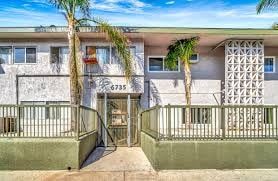 North Hollywood apartment for rent - The image shows a building with the number 6735 on it, surrounded by a metal fence and a gate.