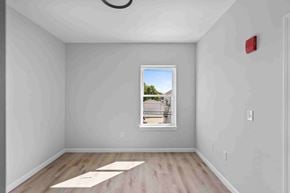 East Providence apartment for rent - A room with a window showing a view of a house and trees.