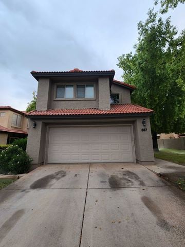 Chandler apartment for rent - A house with a garage door and a driveway.