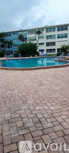 St. Pete Beach apartment for rent - A bedroom with a bed and a wooden dresser.