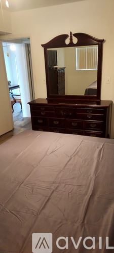 St. Pete Beach apartment for rent - A living room with a couch, chairs, and a ceiling fan.