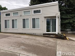Polson condo for rent - A grey building with the number 7 on the door.