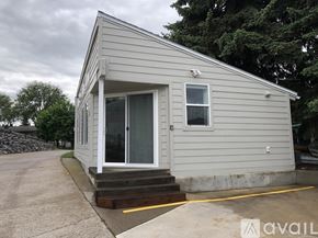 Polson condo for rent - A small house with a grey siding and a white door is available for rent.