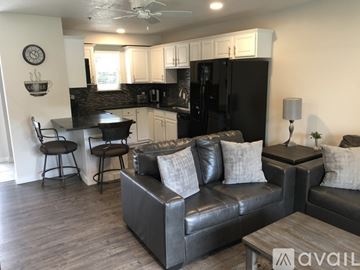 Polson condo for rent - A living room with a black couch and a wooden coffee table.