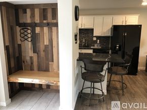 Polson condo for rent - A kitchen with a black fridge and a wooden wall.