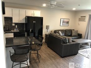 Polson condo for rent - A kitchen with a black fridge and a black table with two chairs.