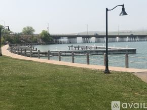 Polson condo for rent - A grassy area with a lamp post and a pier in the background.