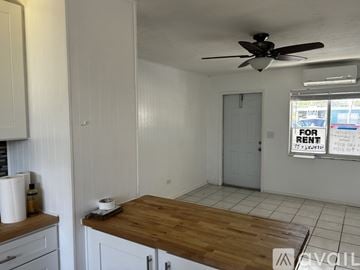 Marathon house for rent - A room with a wooden table and a fan on the ceiling.