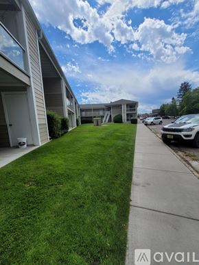 Polson apartment for rent - A row of houses with a grassy sidewalk in front.