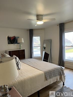 St. Joseph house for rent - A bedroom with a large bed and a ceiling fan.
