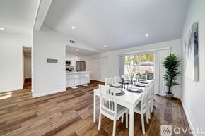 Los Angeles house for rent - A dining room with a white table and chairs.