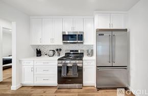 Los Angeles house for rent - A kitchen with white cabinets and stainless steel appliances.