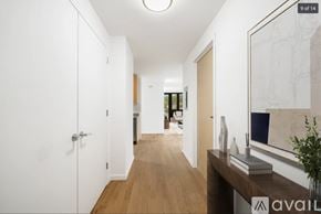 Peekskill apartment for rent - A hallway with a wooden floor and white walls.