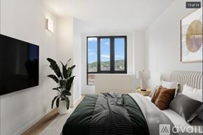 Peekskill apartment for rent - A bedroom with a large bed and a flat screen TV mounted on the wall.