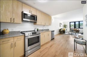 Peekskill apartment for rent - A kitchen with wooden cabinets and a stainless steel oven.