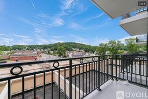 Peekskill apartment for rent - A balcony with a view of a town and buildings.
