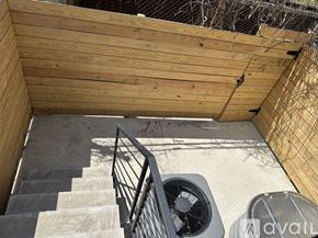 Philadelphia apartment for rent - A wooden deck with a staircase and a fan.