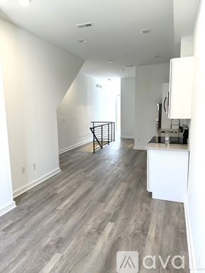 Philadelphia apartment for rent - A spacious room with wooden flooring and white walls.
