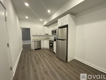 Philadelphia apartment for rent - A kitchen with white cabinets and a refrigerator.