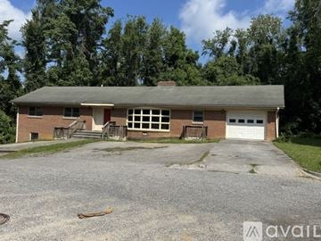 Blacksburg apartment for rent - A two-story house with a garage and a driveway in front.