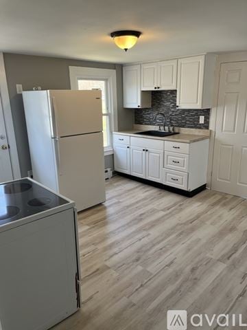 Middletown apartment for rent - A kitchen with a white fridge and cabinets.