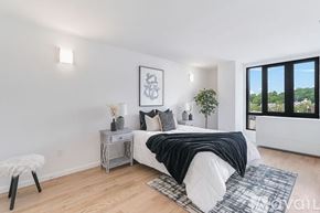 Peekskill apartment for rent - A bedroom with a bed, nightstand, and chair.