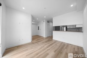 Los Angeles apartment for rent - A spacious room with wooden flooring and white walls.