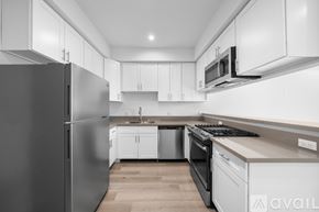 Los Angeles apartment for rent - A modern kitchen with a refrigerator, microwave, and oven.