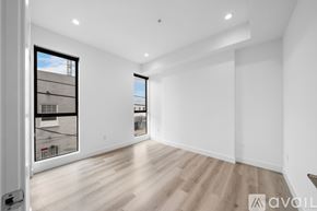 Los Angeles apartment for rent - A spacious room with wooden flooring and a large window.
