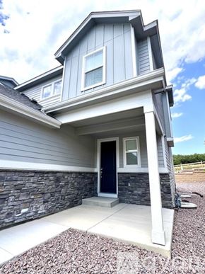 Colorado Springs townhouse for rent - A house with a grey exterior and a dark blue door.