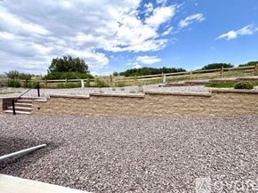 Colorado Springs townhouse for rent - A gravel area with a wooden fence and a bench.