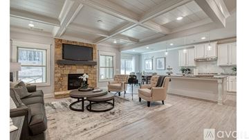 Buford house for rent - A living room with a fireplace and a television mounted above it.