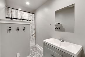 Spartanburg house for rent - A bathroom with a white sink and a mirror.