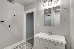 Spartanburg house for rent - A bathroom with a white sink and a mirror above it.
